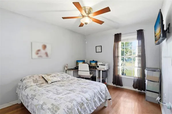 a bedroom with a bed and a chandelier