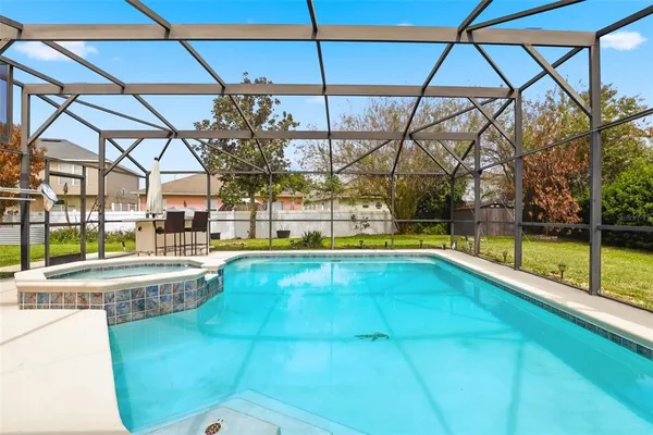 a view of a swimming pool with a yard