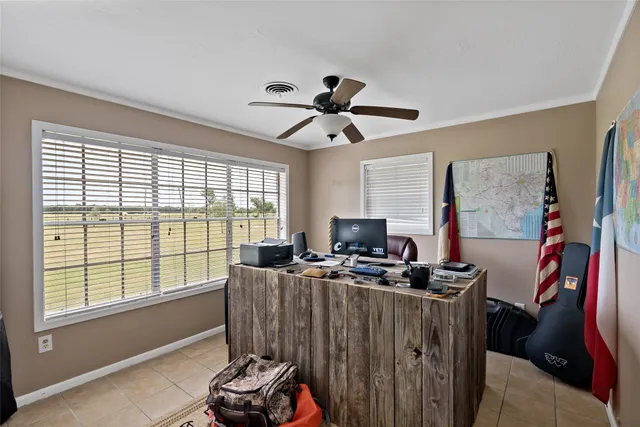 a room with furniture a flat screen tv and a window