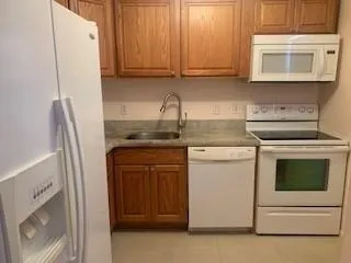 a kitchen with stainless steel appliances granite countertop white cabinets and a stove