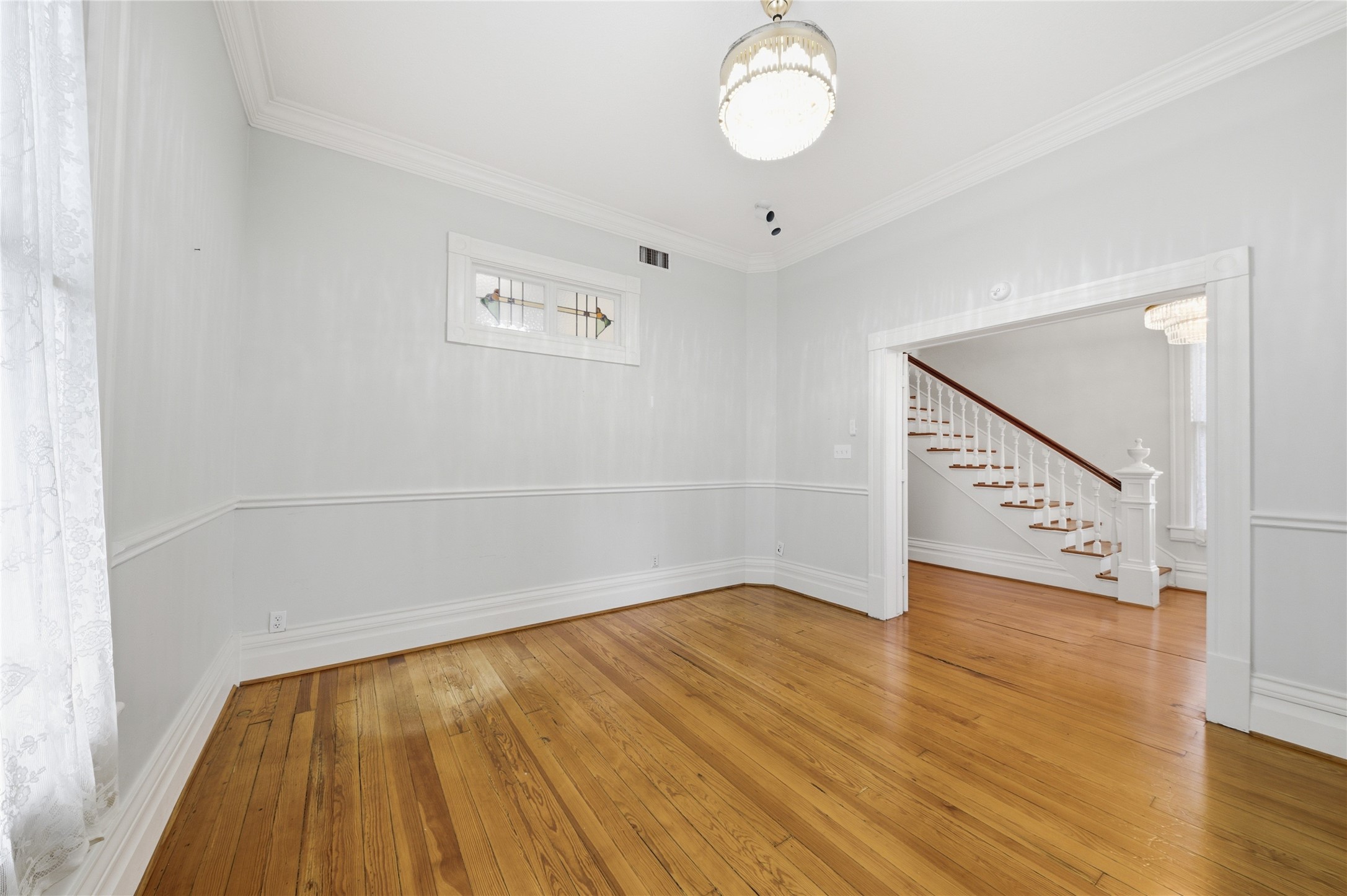 1007 Heights Boulevard Houston, TX 77008 - Photo 17 of 50 a view of an empty room with wooden floor and a window