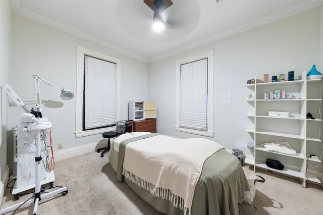 a bedroom with a bed and a flat tv screen on the dresser