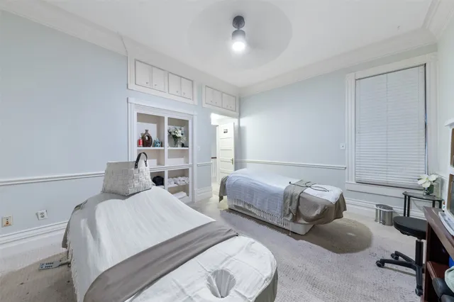 a bedroom with two beds and a chair