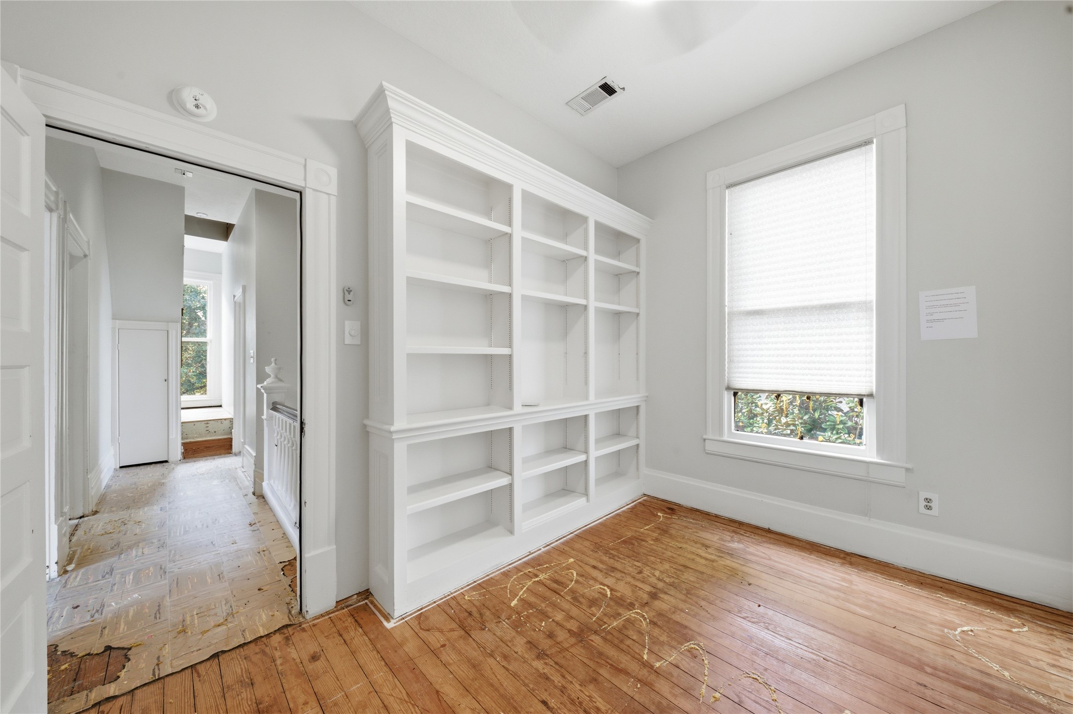 1007 Heights Boulevard Houston, TX 77008 - Photo 30 of 50 a view of an empty room with a window and wooden floor