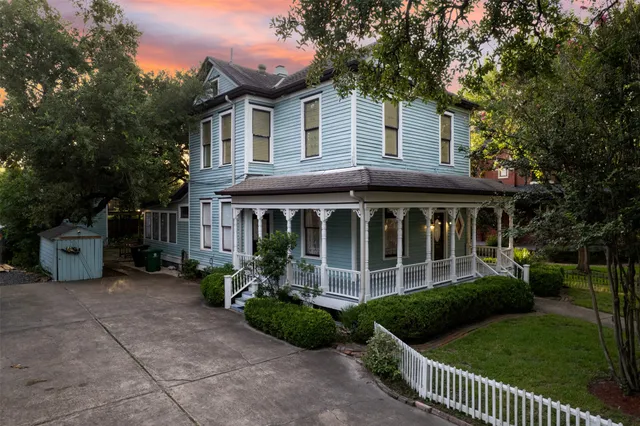 a front view of a house with a garden and plants