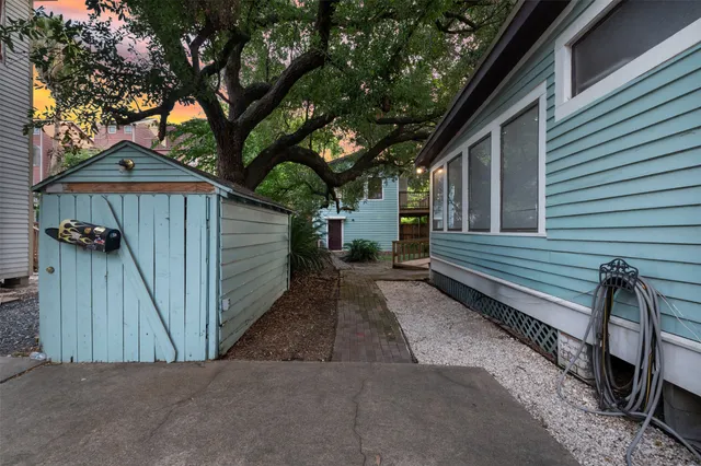 a view of a house with a yard and wooden fence