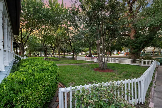a green field with lots of trees