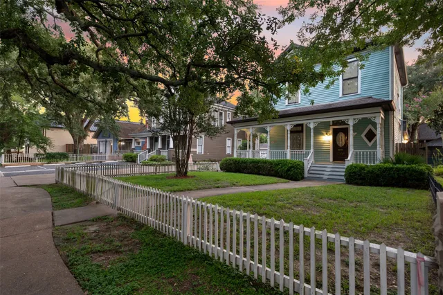 a front view of a house with yard and green space