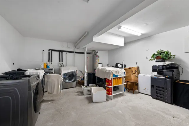 a bedroom with bed and a chandelier