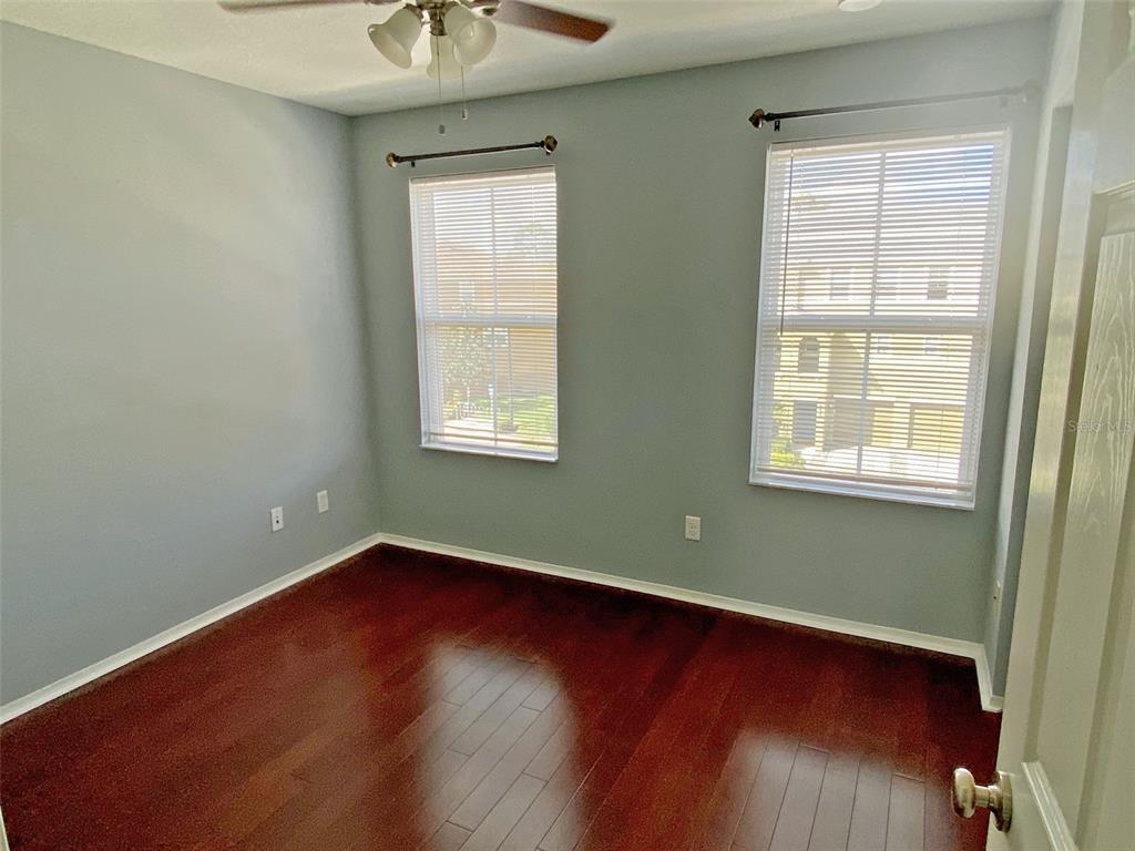 8946 White Sage Loop Lakewood Ranch, FL 34202 - Photo 26 of 36 an empty room with wooden floor and windows