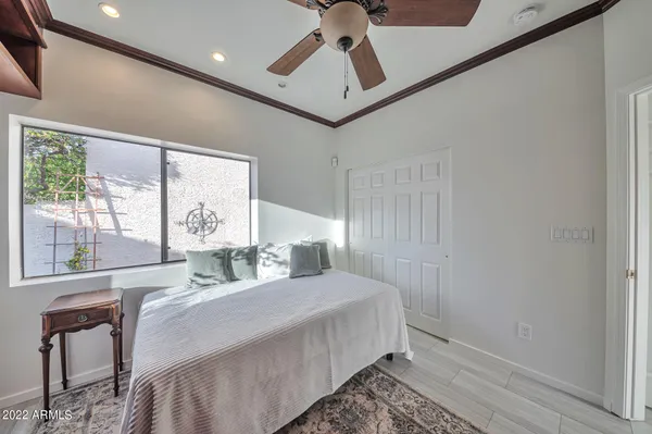 a bedroom with a bed mirror and window