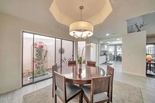a dining room with furniture a chandelier and window