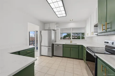 a kitchen with a refrigerator and a sink