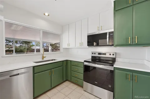 a kitchen with a sink stove and microwave