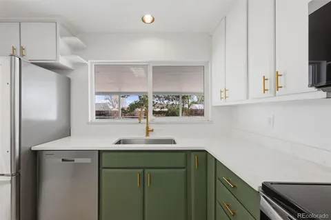 a kitchen with stainless steel appliances cabinets and window