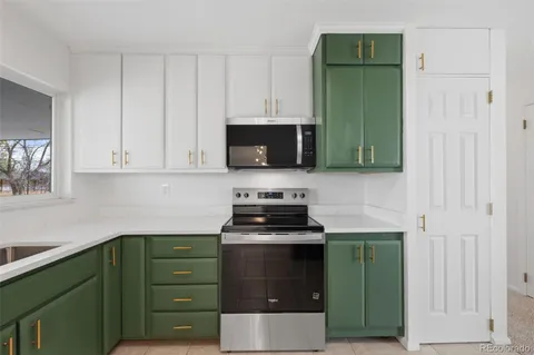 a kitchen with cabinets a microwave and a sink