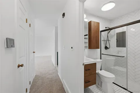 a bathroom with a toilet and a shower