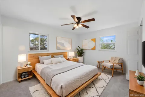 a bedroom with a bed gym equipment and a window