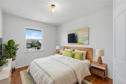 a bedroom with a bed and a potted plant