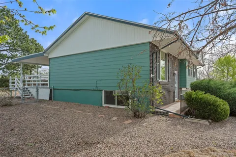 a view of a house with a small yard and plants