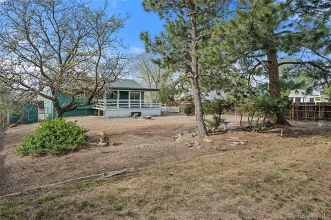 a view of a yard with a house and a tree