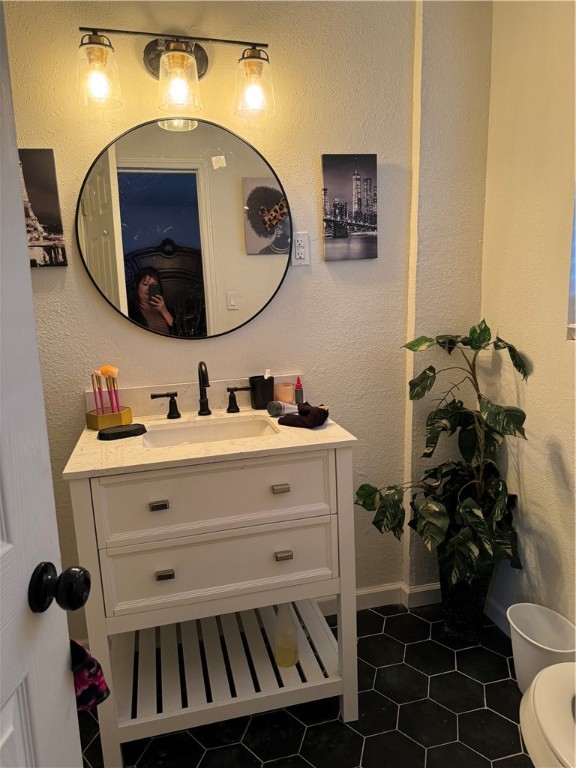 a bathroom with a sink mirror vanity and toilet