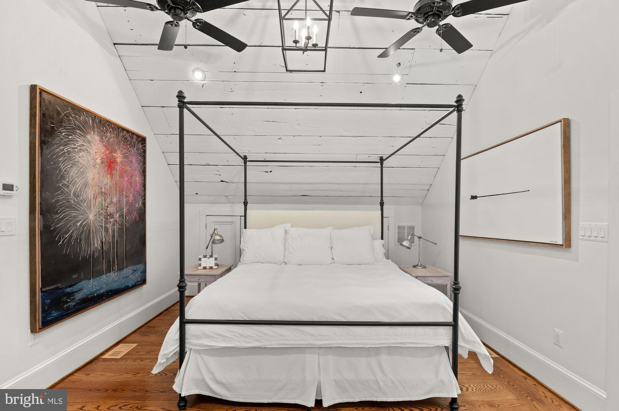 1101 Chain Bridge Road McLean, VA 22101 - Photo 21 of 54 a bed room with a bed and a painting on the wall