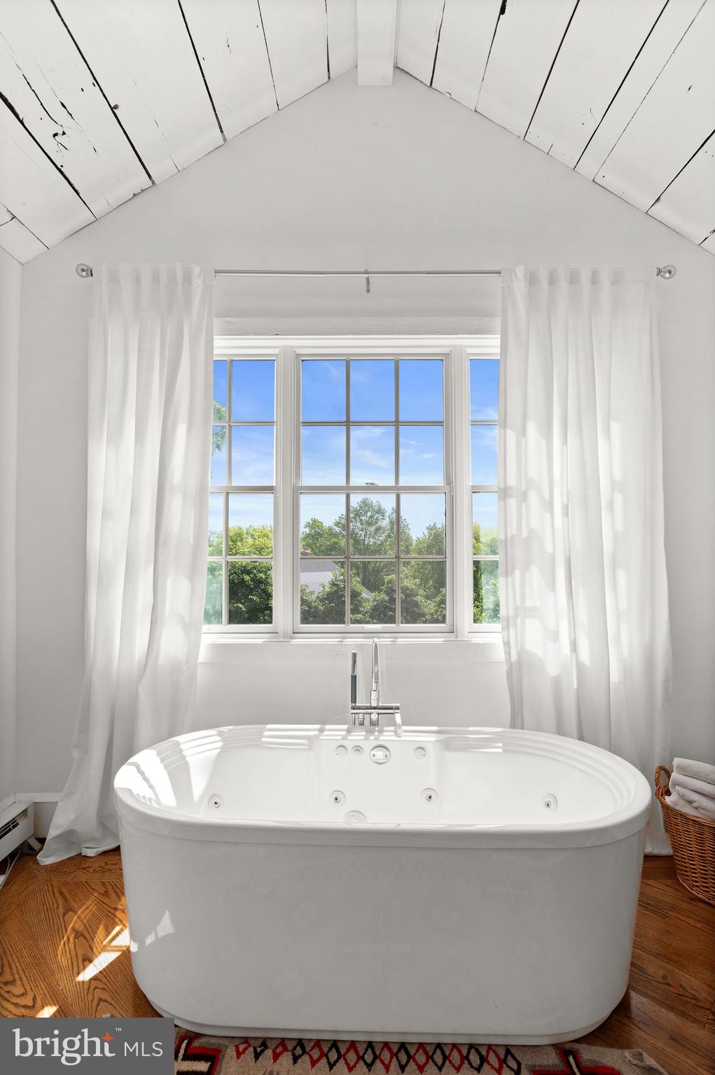 1101 Chain Bridge Road McLean, VA 22101 - Photo 24 of 54 a white bath tub sitting in a bathroom next to a window