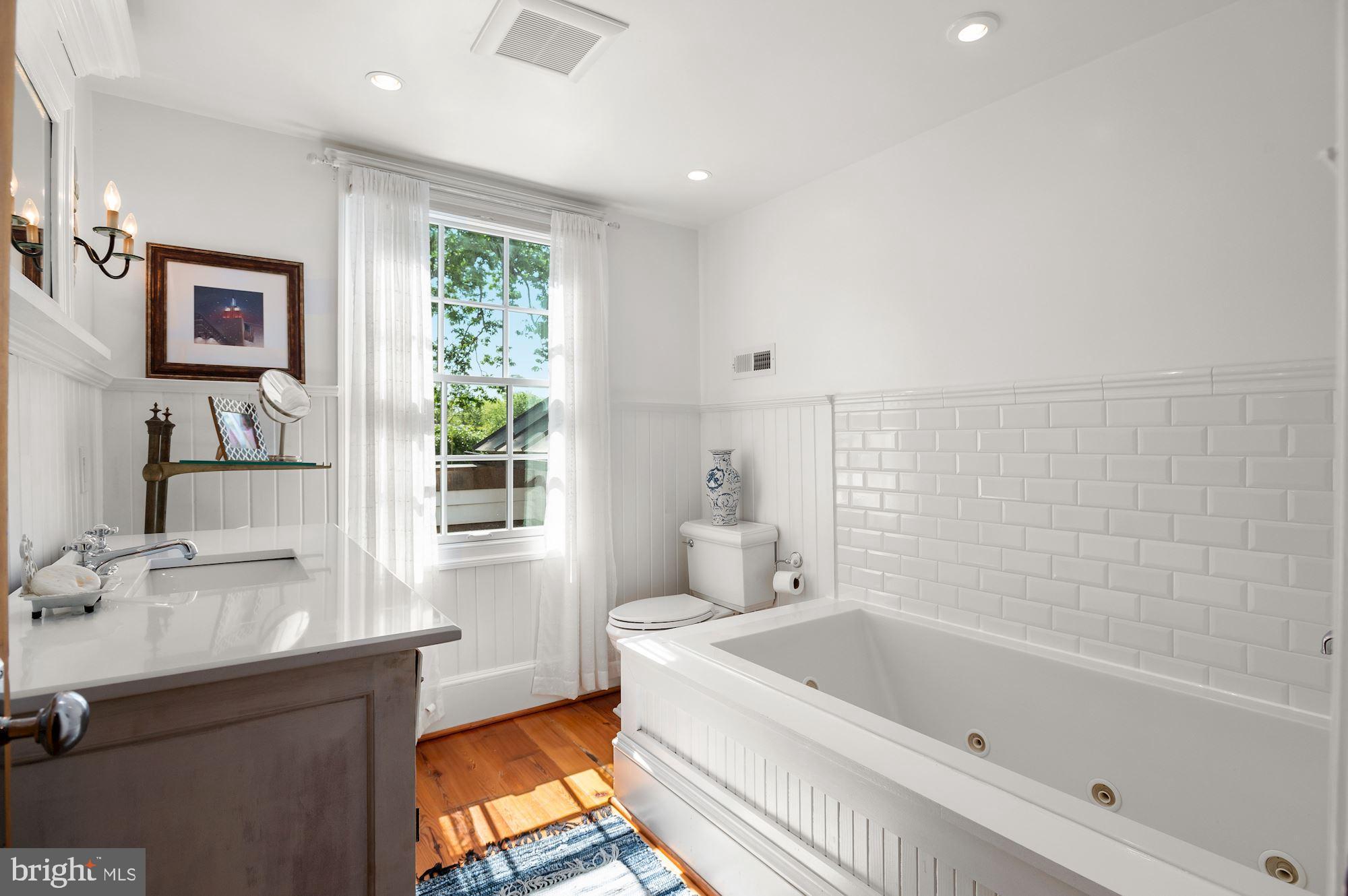 1101 Chain Bridge Road McLean, VA 22101 - Photo 30 of 54 a bathroom with a tub sink and window