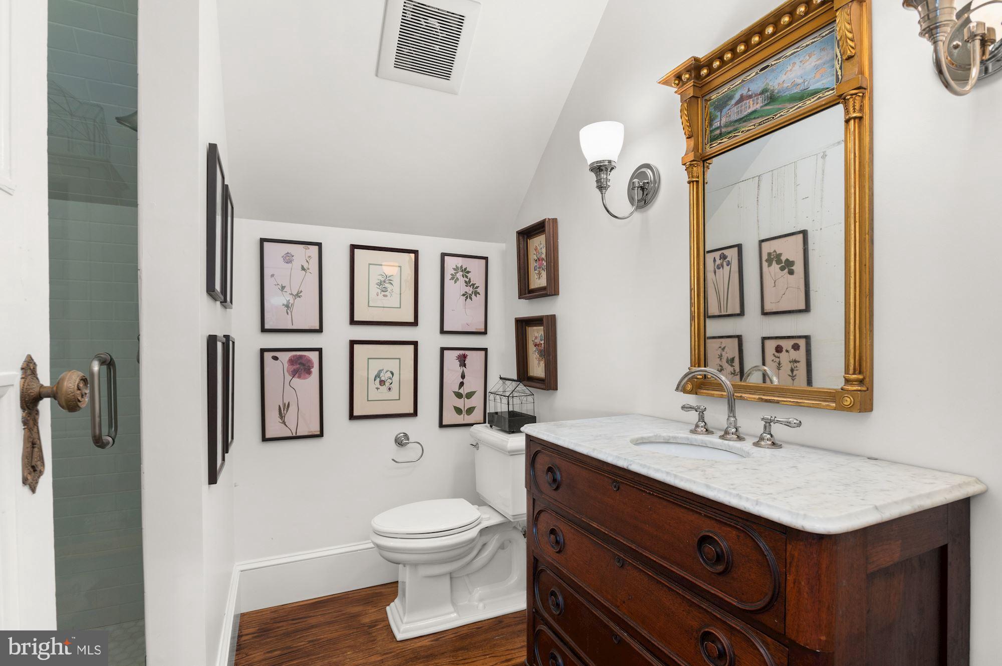 1101 Chain Bridge Road McLean, VA 22101 - Photo 36 of 54 a bathroom with a granite countertop sink mirror vanity and toilet