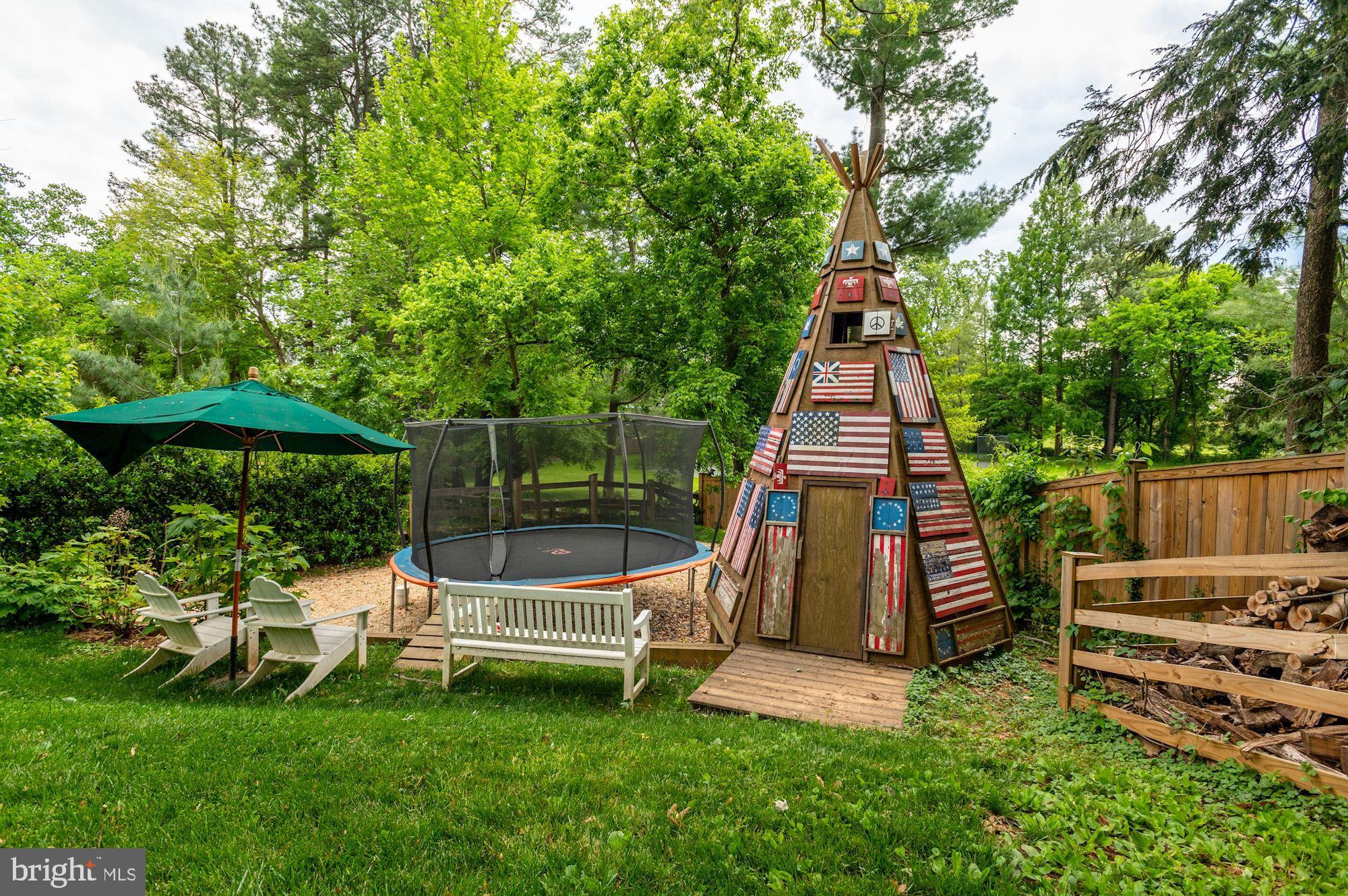 1101 Chain Bridge Road McLean, VA 22101 - Photo 50 of 54 a view of a deck with a table and chair under an umbrella