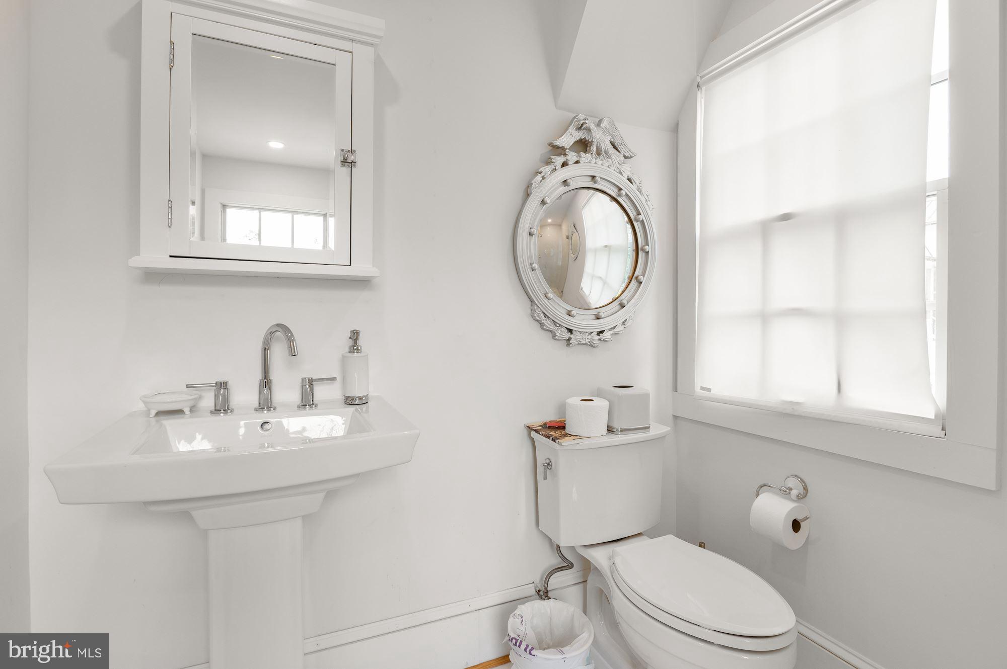 1101 Chain Bridge Road McLean, VA 22101 - Photo 53 of 54 a bathroom with a toilet a sink a vanity and mirror