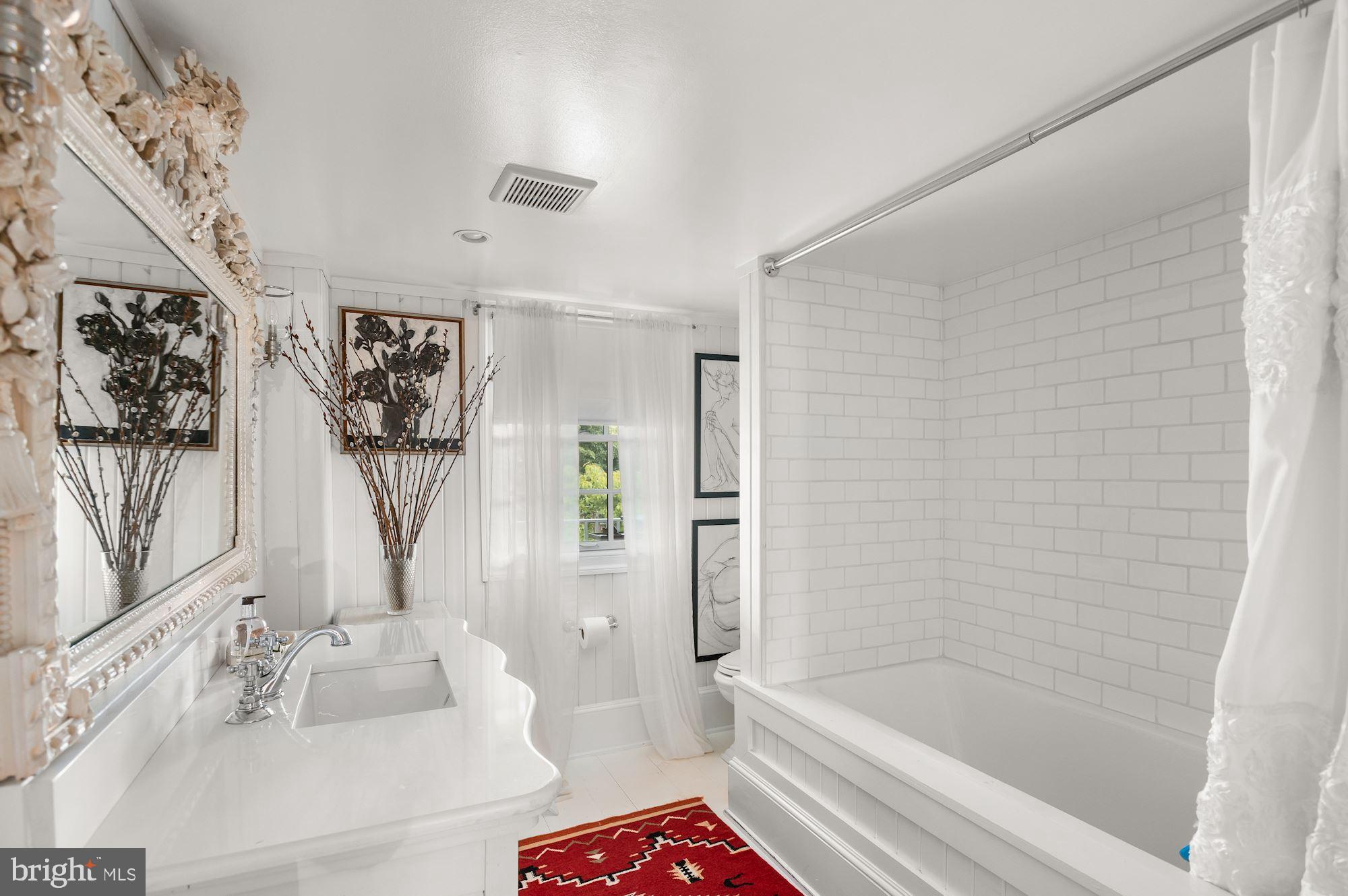 1101 Chain Bridge Road McLean, VA 22101 - Photo 8 of 54 a bathroom with a bathtub a sink and a shower