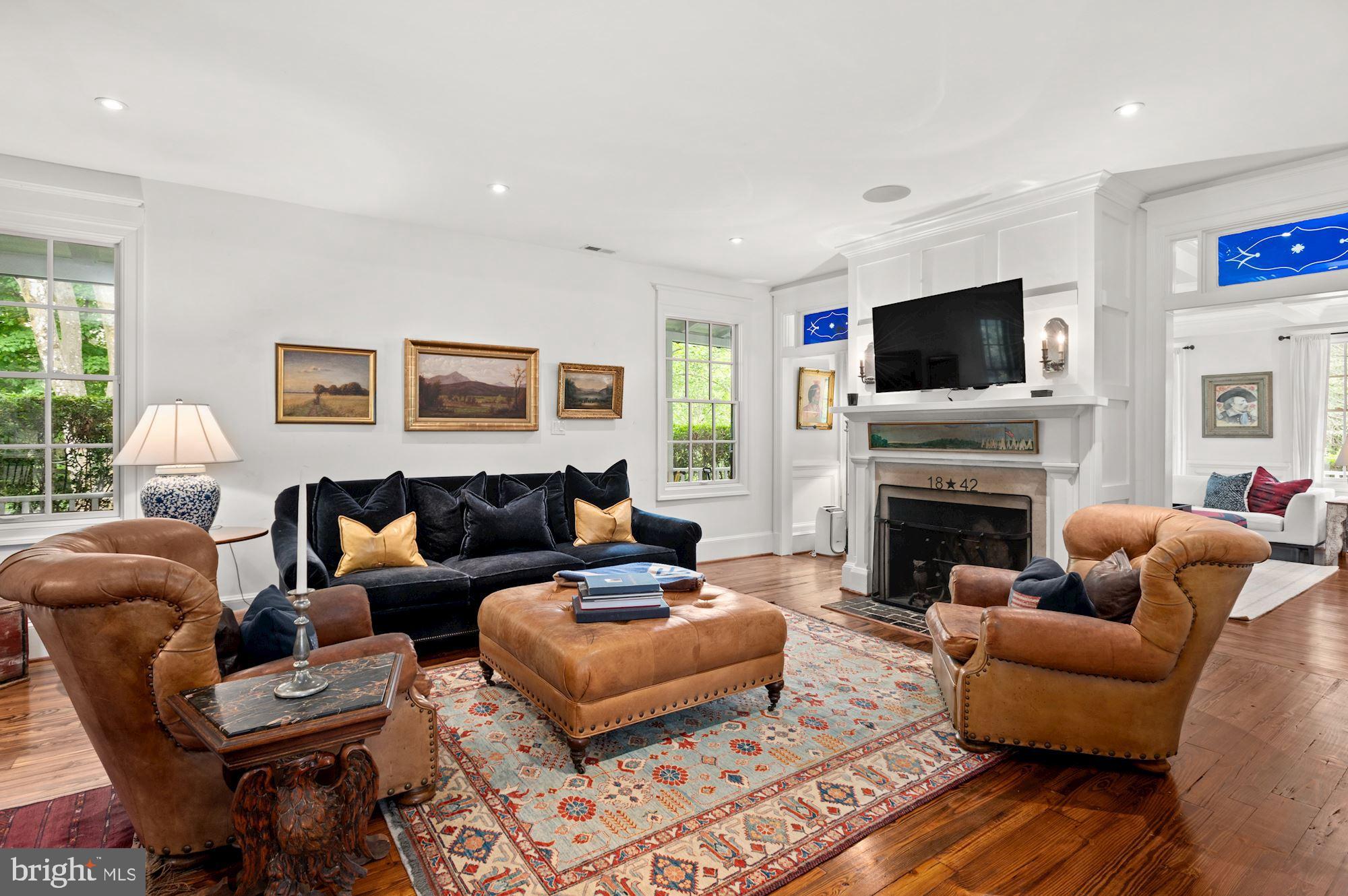 1101 Chain Bridge Road McLean, VA 22101 - Photo 9 of 54 a living room with furniture a flat screen tv and a fireplace