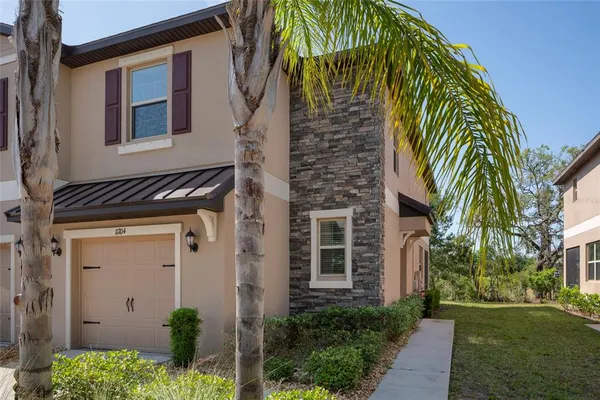 a front view of a house with a garden
