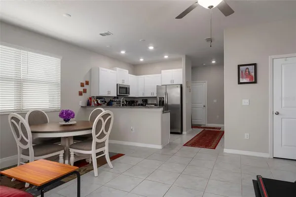 a kitchen with stainless steel appliances granite countertop white cabinets granite counter tops and a window