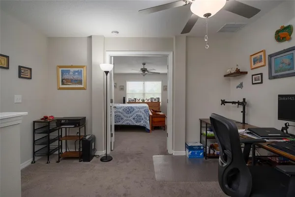 a view of a workspace with furniture and a workspace