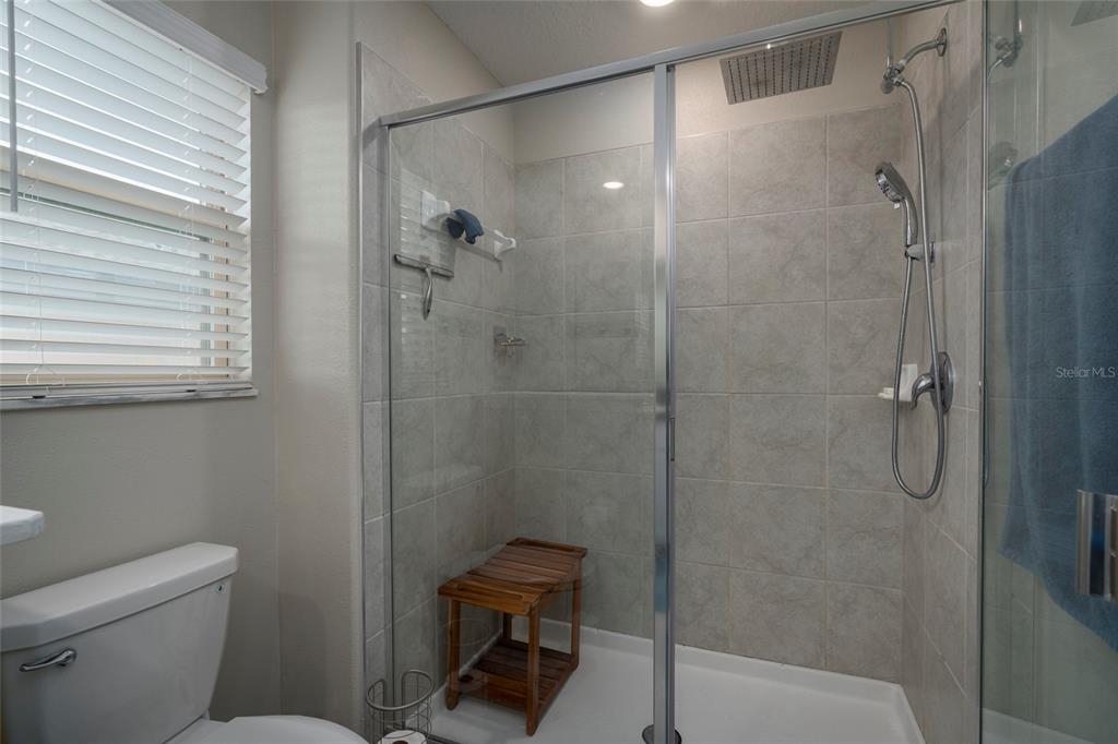 11704 Castine Street New Port Richey, FL 34654 - Photo 26 of 31 a bathroom with a shower and toilet