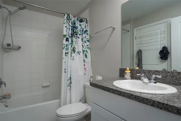 a bedroom with a dresser and a window