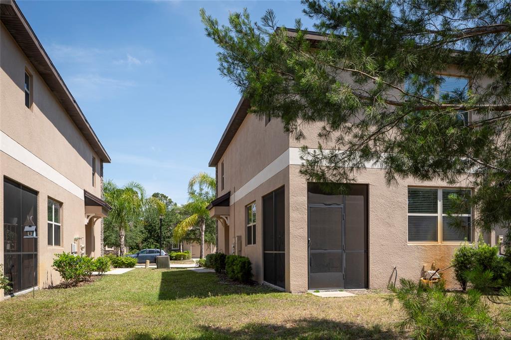 11704 Castine Street New Port Richey, FL 34654 - Photo 7 of 31 a front view of a house with a yard garage and outdoor seating
