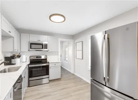 a kitchen with stainless steel appliances a refrigerator stove and sink