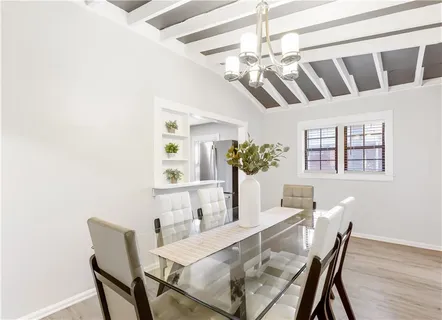 a view of a dining room with furniture and chandelier