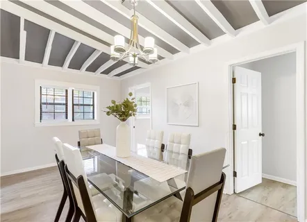a view of a dining room with furniture and a chandelier