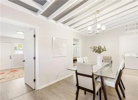 a view of a dining room with furniture and chandelier