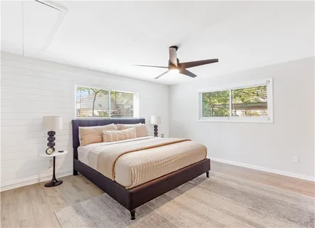 a a spacious bedroom with a bed and a large window