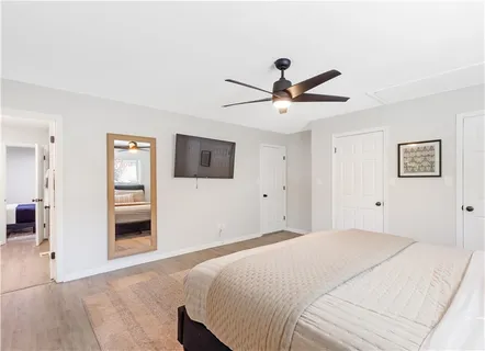 a bedroom with a large bed and a chandelier