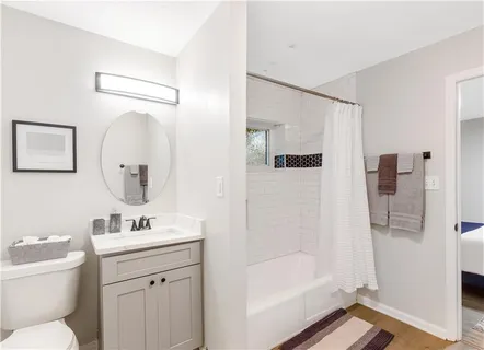 a bathroom with a toilet sink and shower