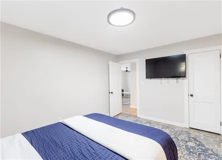 a bedroom with a bed and a flat screen tv