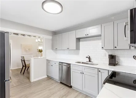 a kitchen with a sink cabinets and window