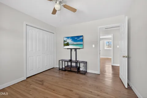 a view of a big room with wooden floor and windows in a room